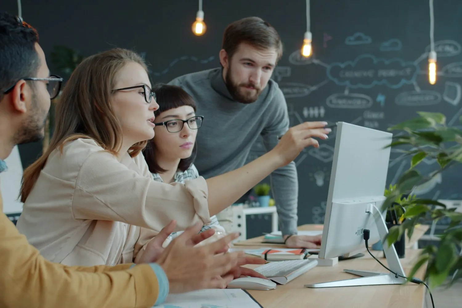 A team collaborating at a screen